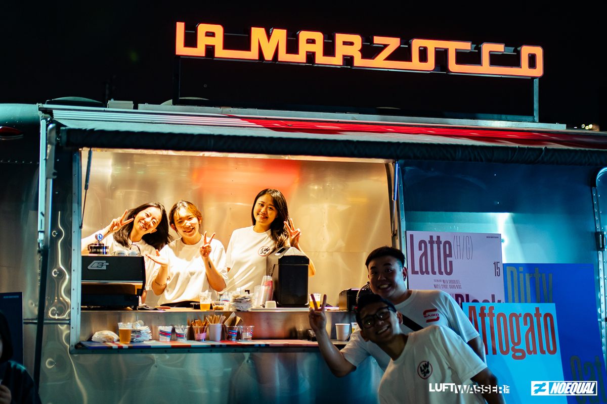 Crew serving coffee from the La Marzocco truck at night