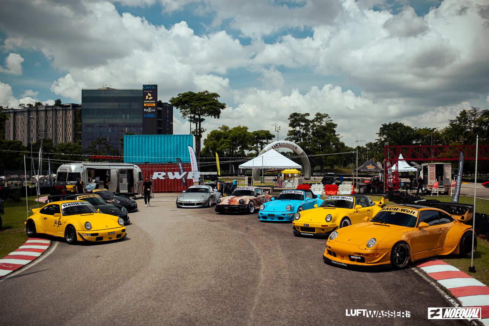 Line-up of RAUH-Welt Begriff widebody 911s beside the RWB container
